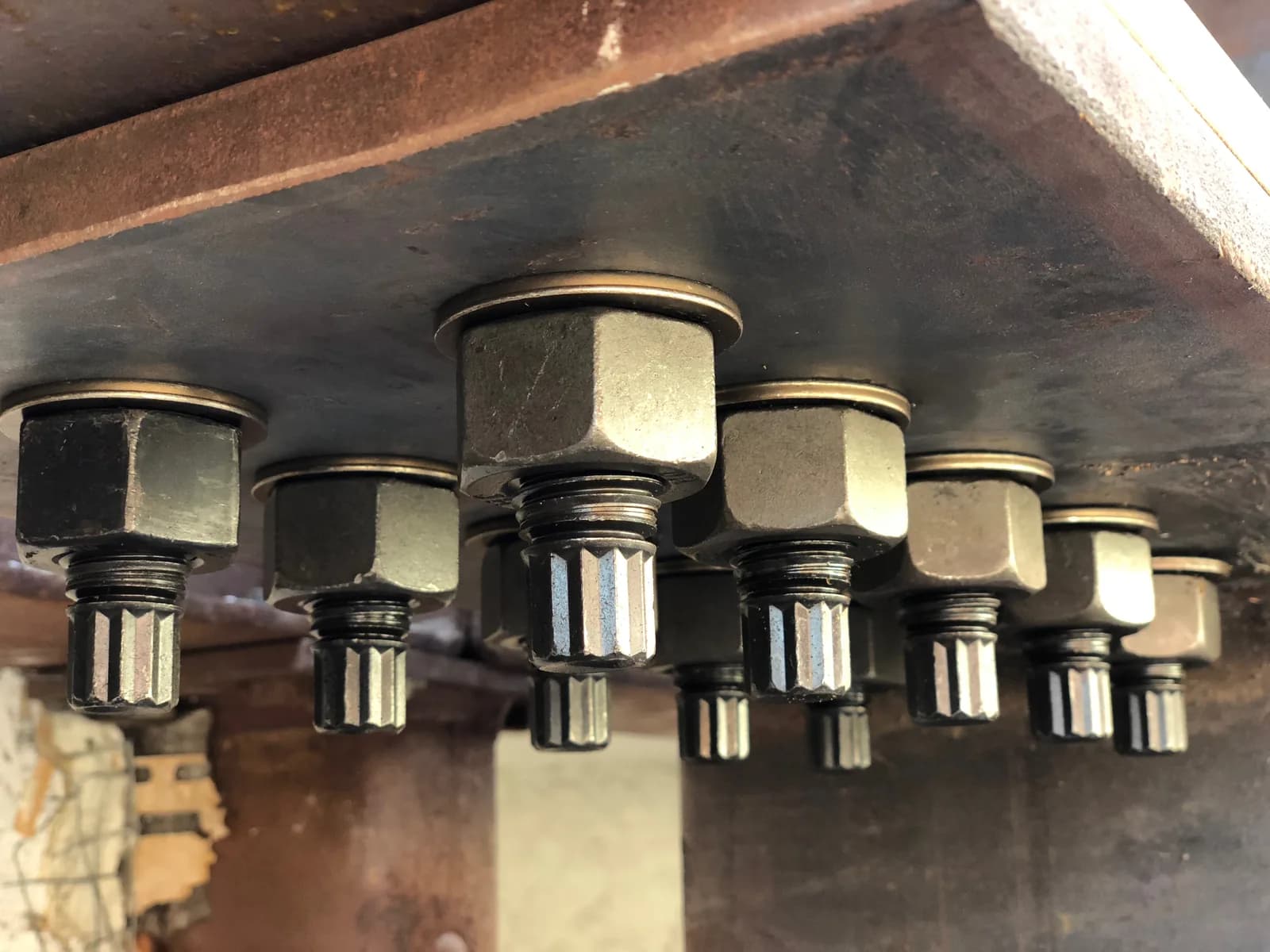 Close-up of structural tension-control bolts on a Cal Retrofit steel moment-frame connection.
