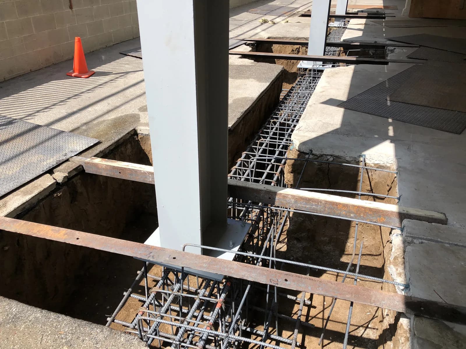 Reinforcing-steel footing cages and a new steel column at a soft-story retrofit foundation